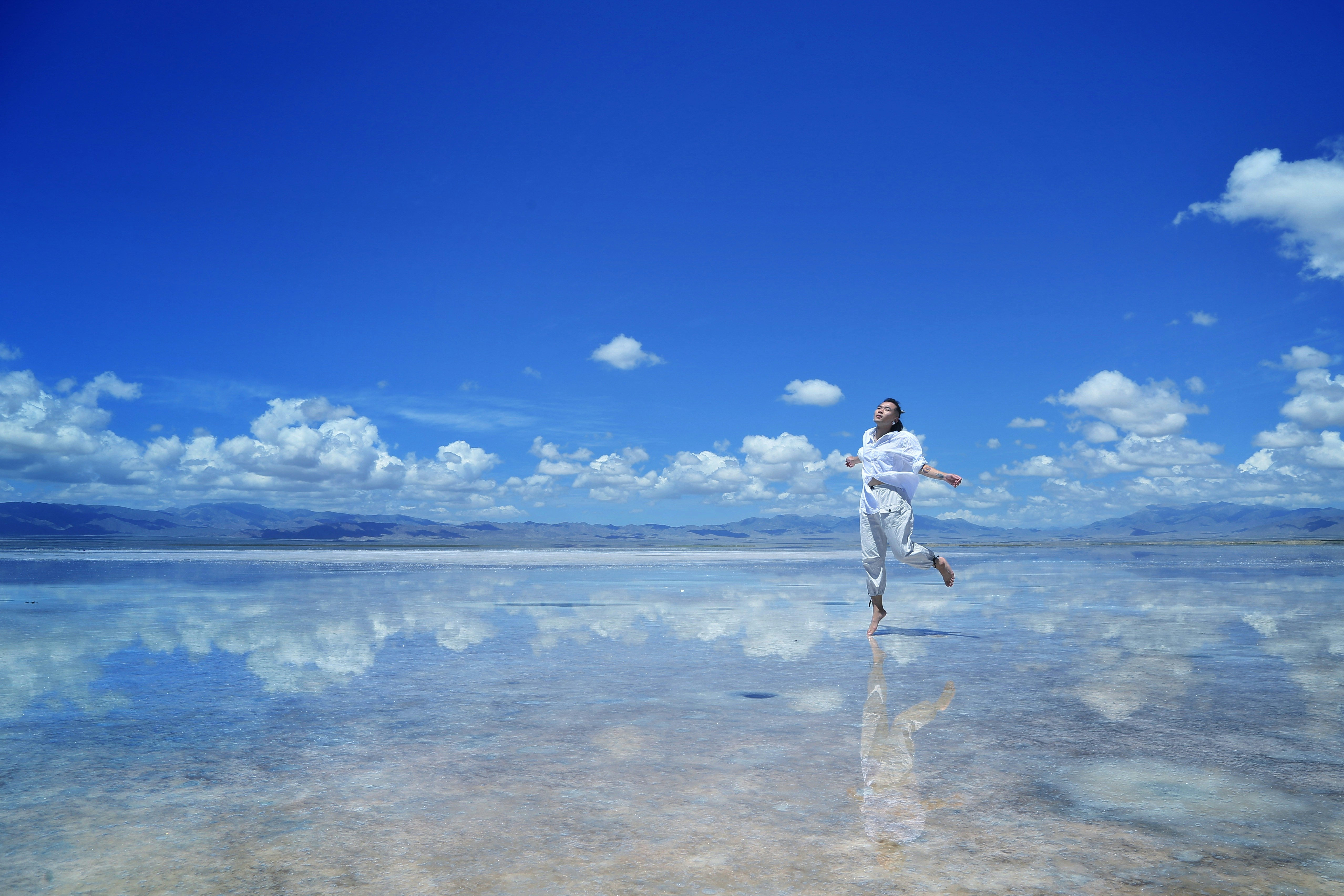 woman on a beach against a sky